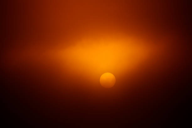 istock A sun disc shining through the mist during the summer sunrise. 1326051887