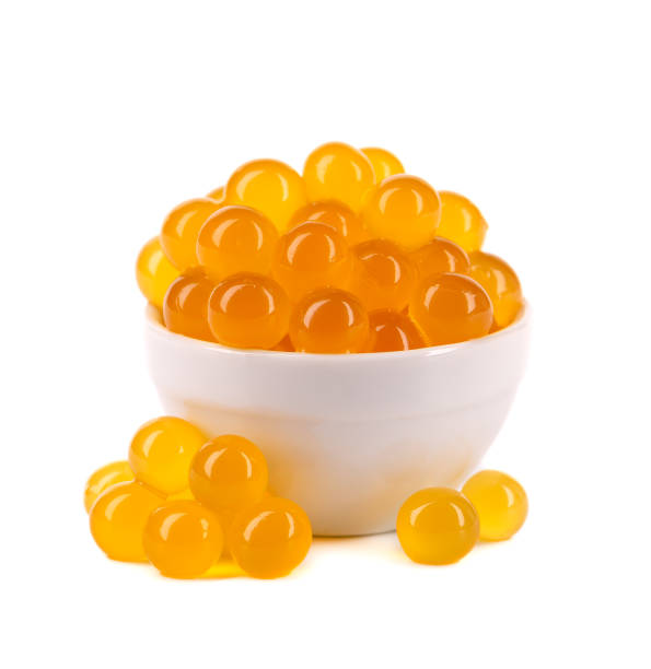 istock Red tapioca pearls for bubble tea isolated on white background. Tapioca pearls in white ceramic spoon. 1326052827