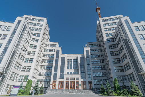Facade of the Derzhprom or the House of State Industry. The building is in the style of international constructivism. Kharkiv, Ukraine - June 2021.