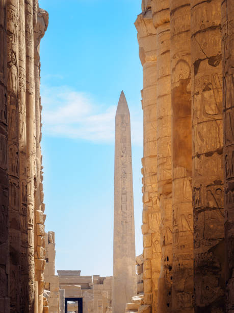Karnak temple with ancient Egyptian columns and obelisk of Queen Hatshepsut, Luxor. Ancient columns and great Egyptian obelisk of Queen Hatshepsut in Karnak temple, Luxor. Architectural landmarks and famous monuments, photo for the travel guide to Egypt. queen hatshepsut stock pictures, royalty-free photos & images