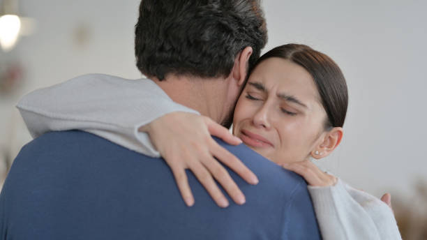 istock Crying Spanish Woman Hugging Man at Home 1326054426
