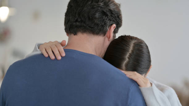 Crying Hispanic Woman Hugging Man at Home Crying Hispanic Woman Hugging Man at Home husband and wife stock pictures, royalty-free photos & images