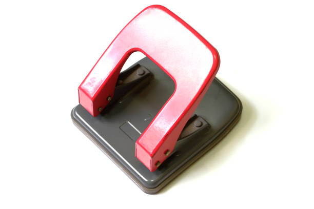 istock Red paper hole puncher isolated on white background 1326054891