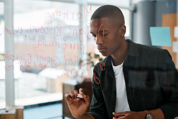 istock Shot of a young businessman making notes in a modern office 1326055796