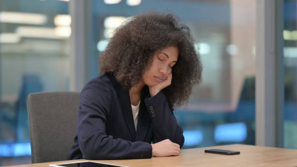 istock African Businesswoman Taking Nap at Work 1326055828
