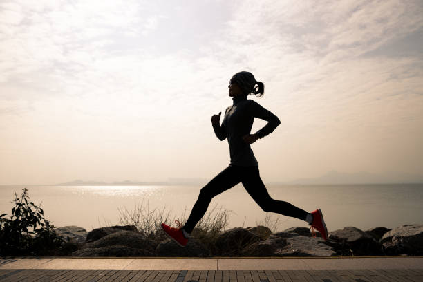 istock Fitness woman running on winter coast 1326057724