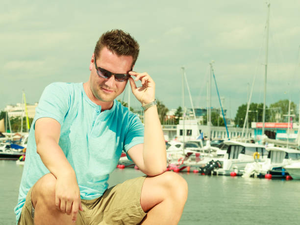 istock Man walking on marina during summer 1326058628