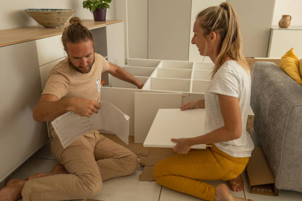 istock Young couple self assembling furniture at home 1326058760