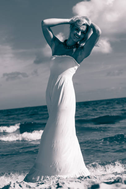 istock Beautiful woman on sunny beach. 1326058984