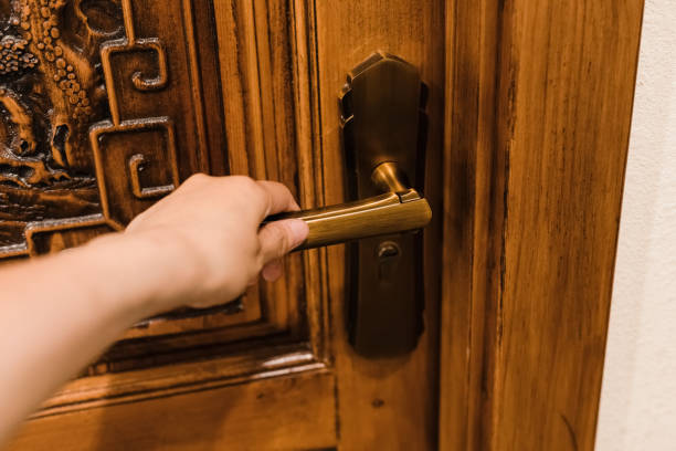 istock Close-up of hand holding doorknob 1326059956