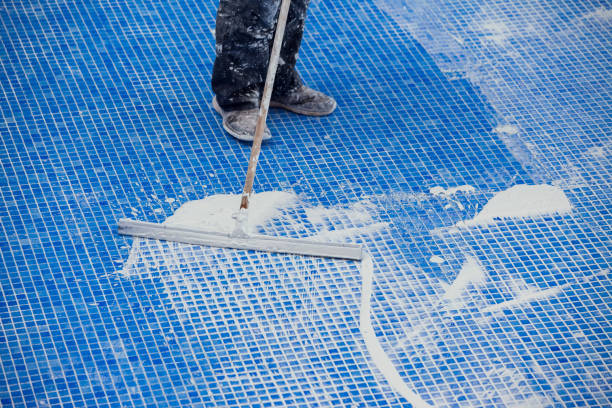 istock Covering seames on the tile in the pool. Pool repairing work 1326060461
