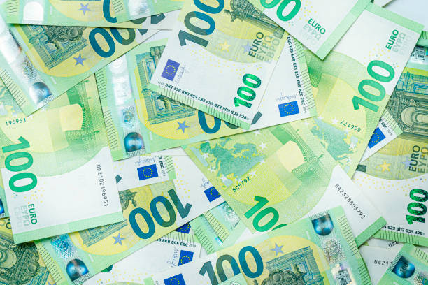 background of one hundred euro bills. - one hundred euro banknote imagens e fotografias de stock
