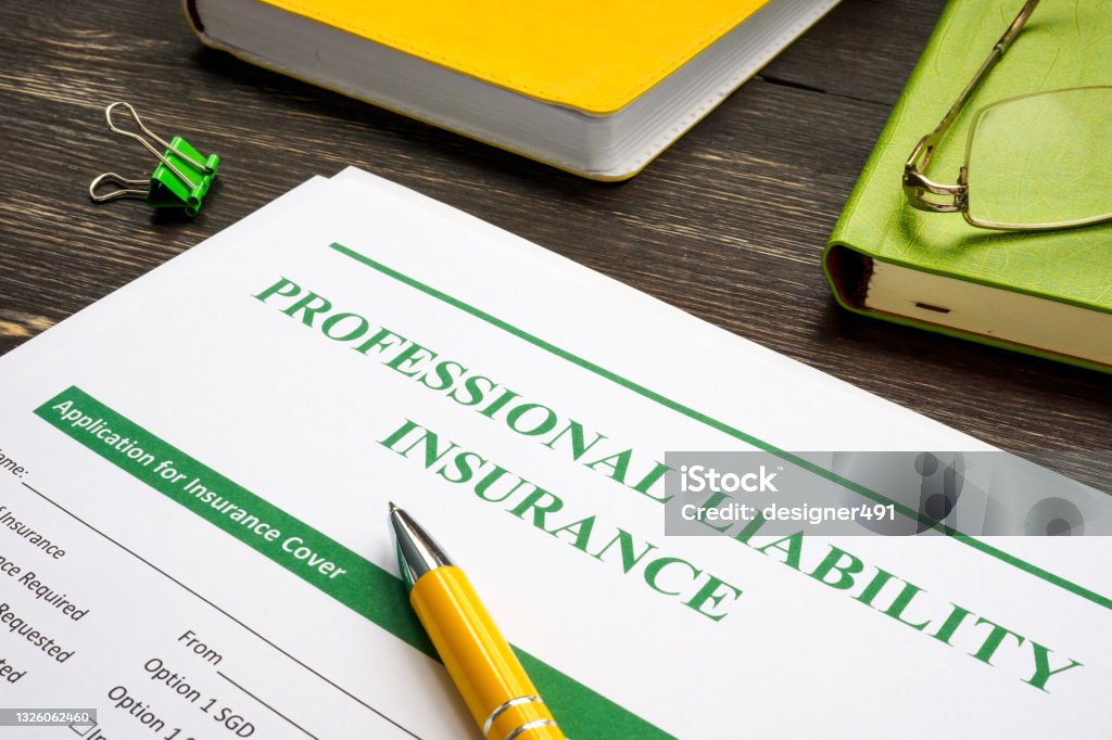 Professional liability insurance and yellow pen for signing. Chance Stock Photo