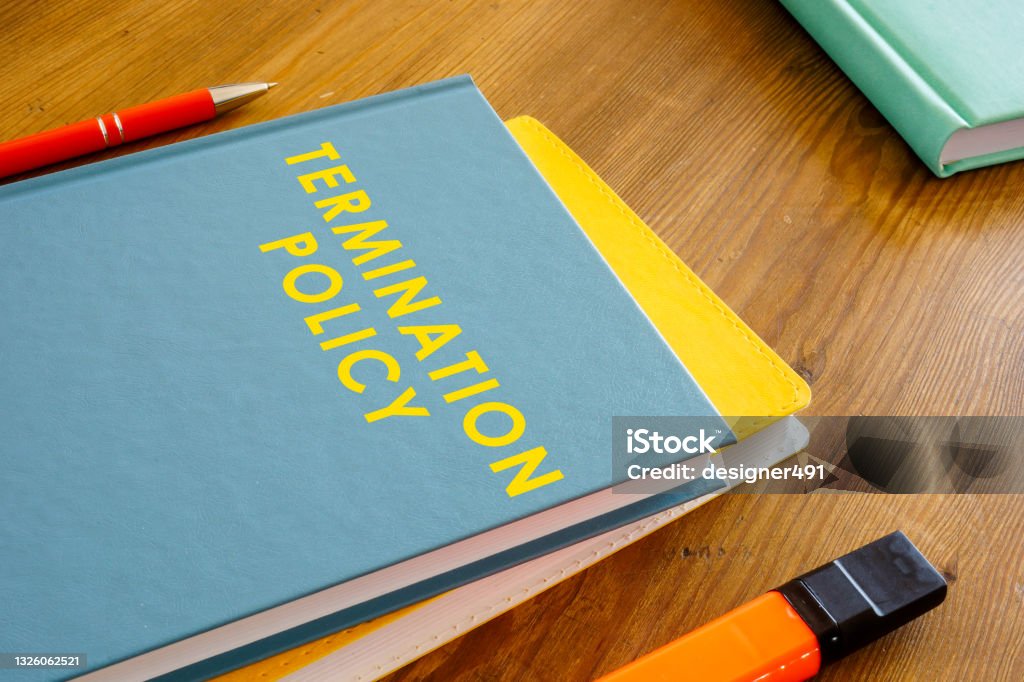 Termination policy guide on the wooden surface. Finishing Stock Photo