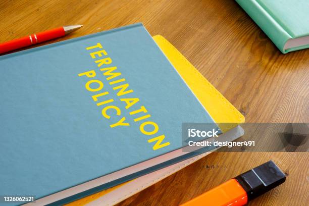 Termination Policy Guide On The Wooden Surface Stock Photo - Download Image Now - Finishing, Being Fired, Employee