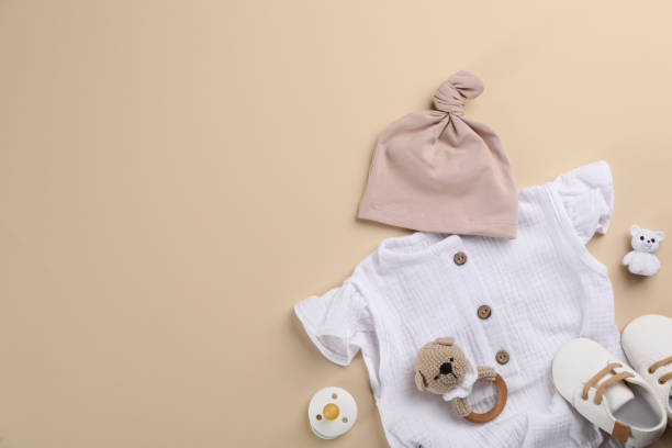 istock Flat lay composition with baby clothes and accessories beige background, space for text 1326062586