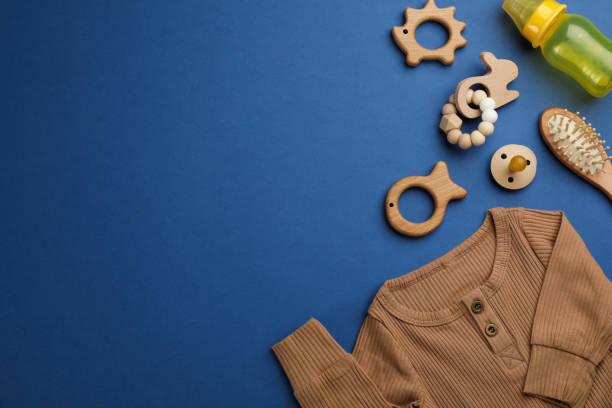 istock Flat lay composition with baby clothes and accessories on blue background, space for text 1326062673