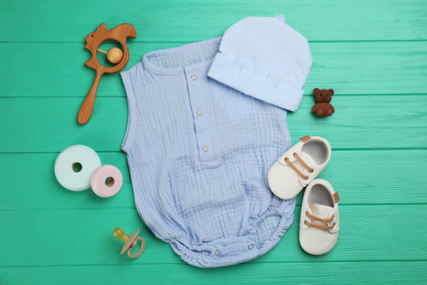 istock Flat lay composition with baby clothes and accessories on turquoise wooden table 1326062873