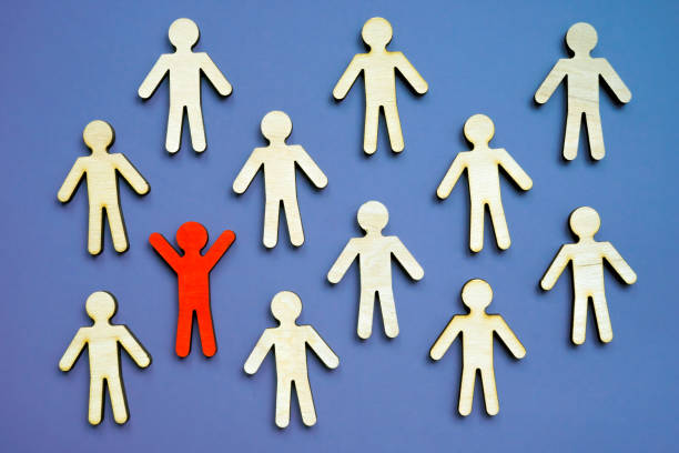 istock Be different concept. One unique figurine in the crowd as symbol of uniqueness. 1326063767