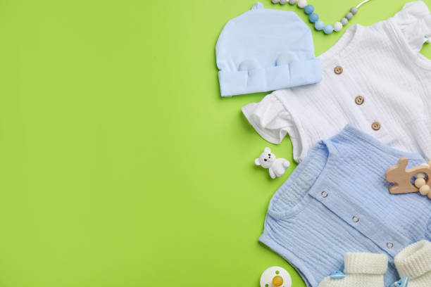 istock Flat lay composition with baby clothes and accessories on green background, space for text 1326064022