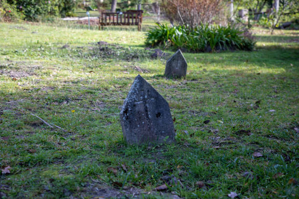 istock Old stone gravestones in a church graveyard 1326064045