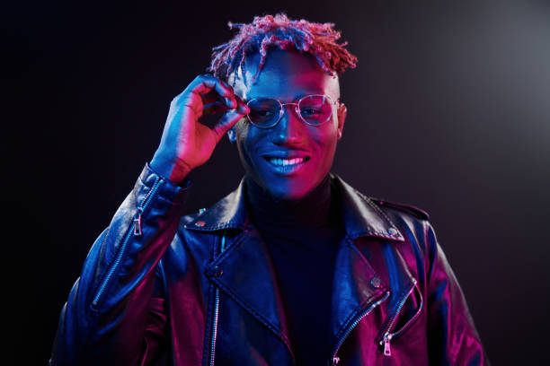 istock Futuristic neon lighting. Young african american man in glasses standing in studio 1326066200