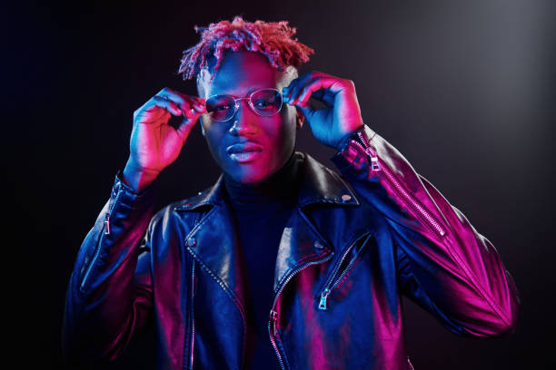istock Futuristic neon lighting. Young african american man in glasses standing in studio 1326066225