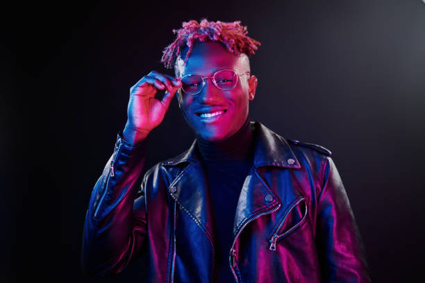 istock Futuristic neon lighting. Young african american man in glasses standing in studio 1326066257