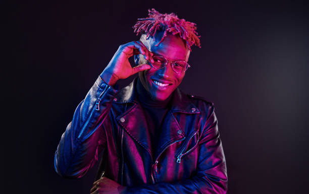 istock Having fun. Futuristic neon lighting. Young african american man in the studio 1326066411