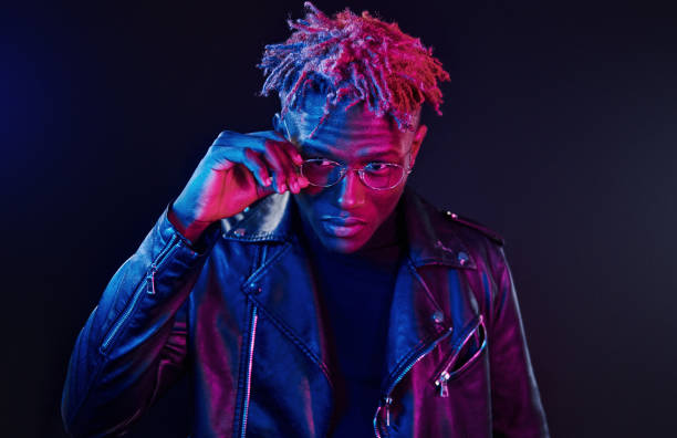 istock Having fun. Futuristic neon lighting. Young african american man in the studio 1326066475