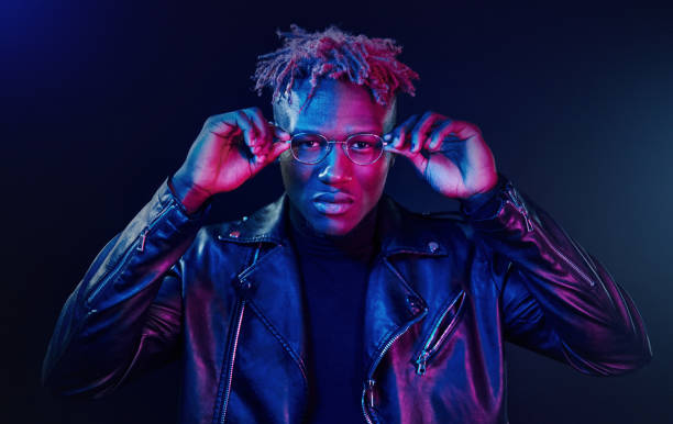 istock Having fun. Futuristic neon lighting. Young african american man in the studio 1326066476
