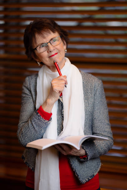 istock Woman with pen and notepad thinking what to write 1326067118
