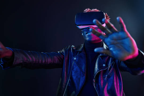 istock Virtual reality experience. Futuristic neon lighting. Young african american man in the studio 1326067127
