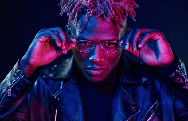istock Having fun. Futuristic neon lighting. Young african american man in the studio 1326067128