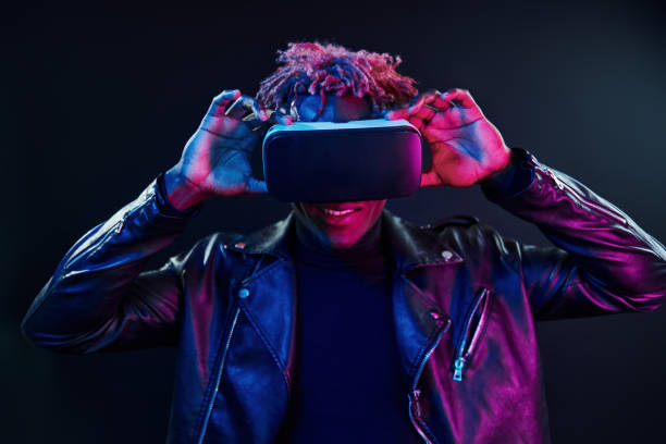 istock Virtual reality experience. Futuristic neon lighting. Young african american man in the studio 1326067136