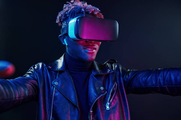 istock Virtual reality experience. Futuristic neon lighting. Young african american man in the studio 1326067260