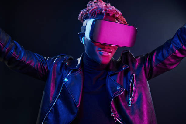 istock Virtual reality experience. Futuristic neon lighting. Young african american man in the studio 1326067297