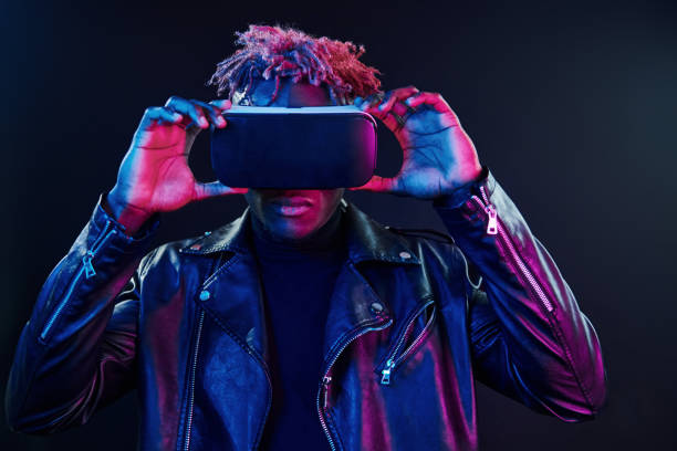 istock Virtual reality experience. Futuristic neon lighting. Young african american man in the studio 1326067298