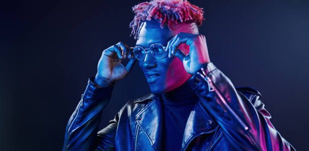 istock Having fun. Futuristic neon lighting. Young african american man in the studio 1326067314
