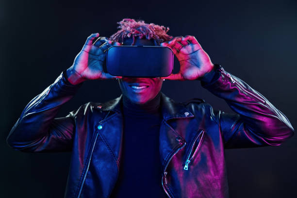 istock Virtual reality experience. Futuristic neon lighting. Young african american man in the studio 1326067418