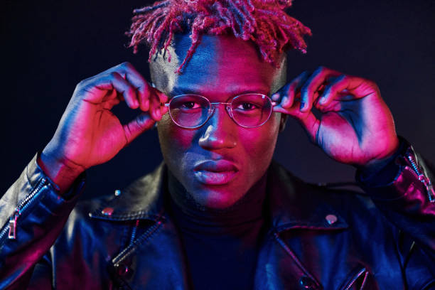 istock Having fun. Futuristic neon lighting. Young african american man in the studio 1326067420