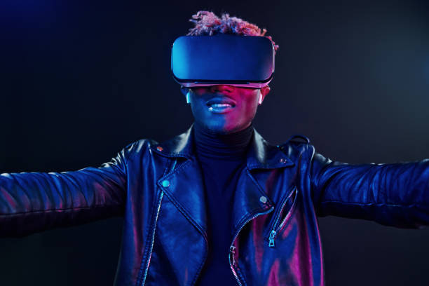 istock Virtual reality experience. Futuristic neon lighting. Young african american man in the studio 1326067560