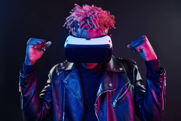 istock Virtual reality experience. Futuristic neon lighting. Young african american man in the studio 1326067620