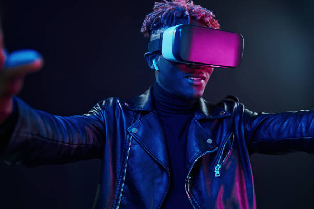 istock Virtual reality experience. Futuristic neon lighting. Young african american man in the studio 1326067622