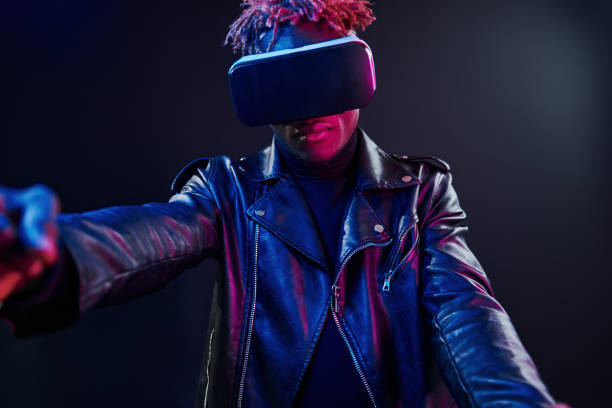 istock Virtual reality experience. Futuristic neon lighting. Young african american man in the studio 1326067799