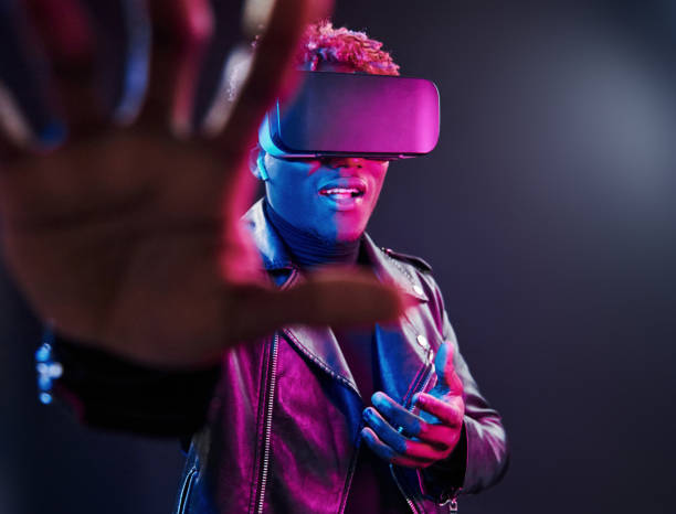 istock Virtual reality experience. Futuristic neon lighting. Young african american man in the studio 1326067916