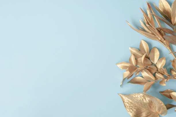golden leaves on blue pastel background