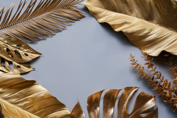 istock Group of golden leaves on a dark black background (monstela leaves, coconut, banana leaves, fern, palm) 1326068545