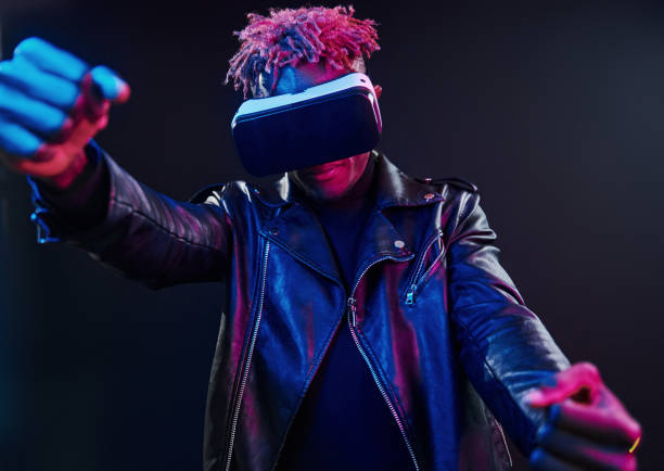 istock Virtual reality experience. Futuristic neon lighting. Young african american man in the studio 1326068629