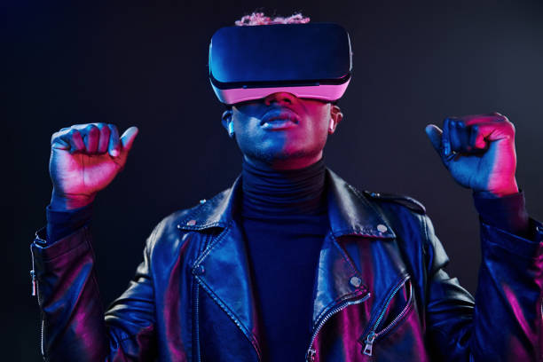 istock Virtual reality experience. Futuristic neon lighting. Young african american man in the studio 1326068630